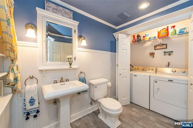 a bathroom with a sink vanity mirror and toilet