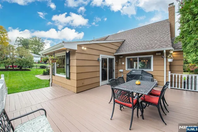 a view of a house with a yard and sitting area