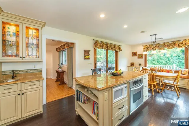 a kitchen with a stove and wooden floor