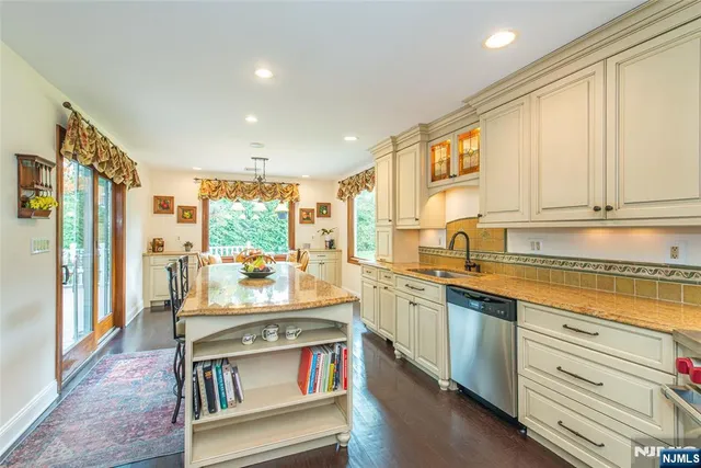a kitchen with stainless steel appliances granite countertop sink stove and refrigerator