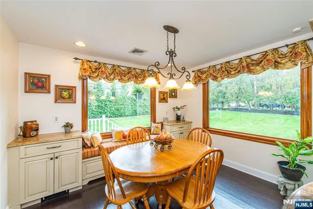 a dining room with furniture a chandelier and wooden floor
