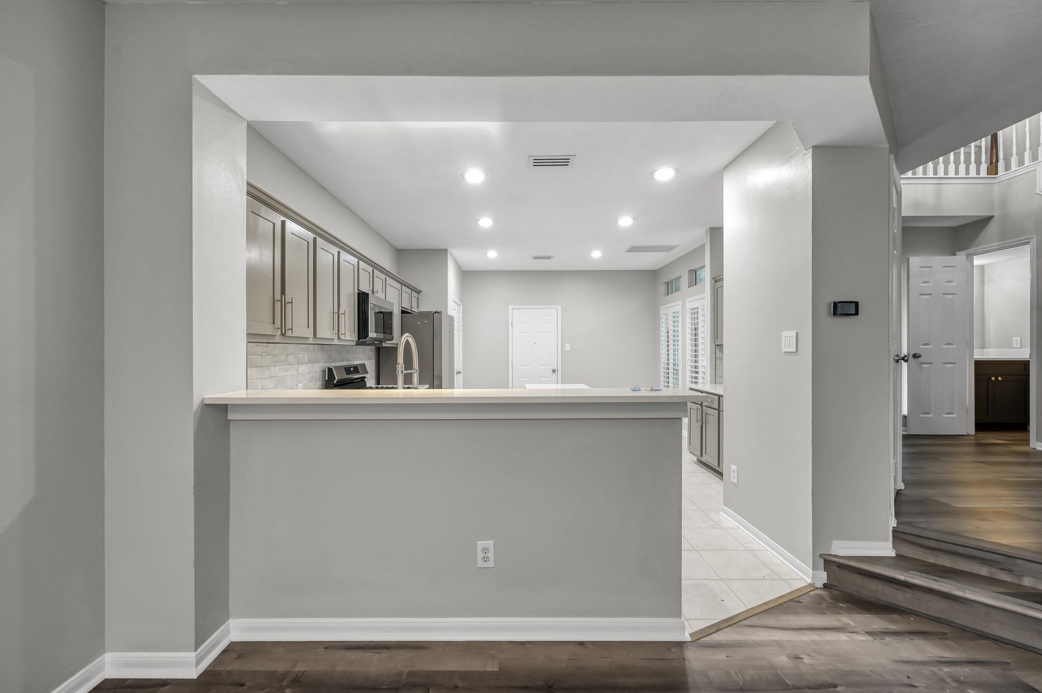 23 Alderon Woods Place Spring, TX 77382 - Photo 11 of 25 a kitchen with stainless steel appliances a refrigerator and wooden floor
