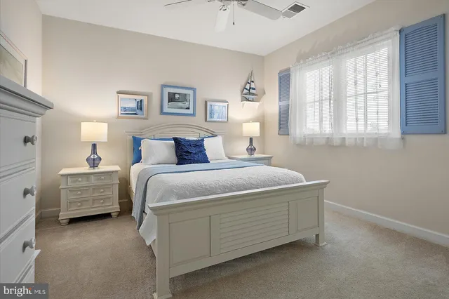 an aerial view of ocean and residential houses with outdoor space