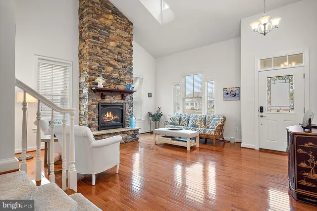 a kitchen with stainless steel appliances a refrigerator a stove a sink a dining table and chairs