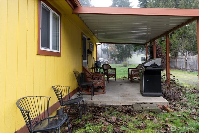 a view of a patio with table and chairs potted plants with wooden floor