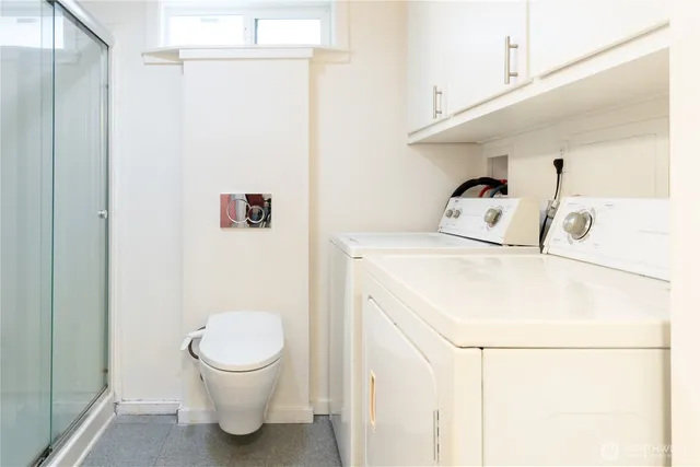 a bathroom with a sink a toilet and a shower