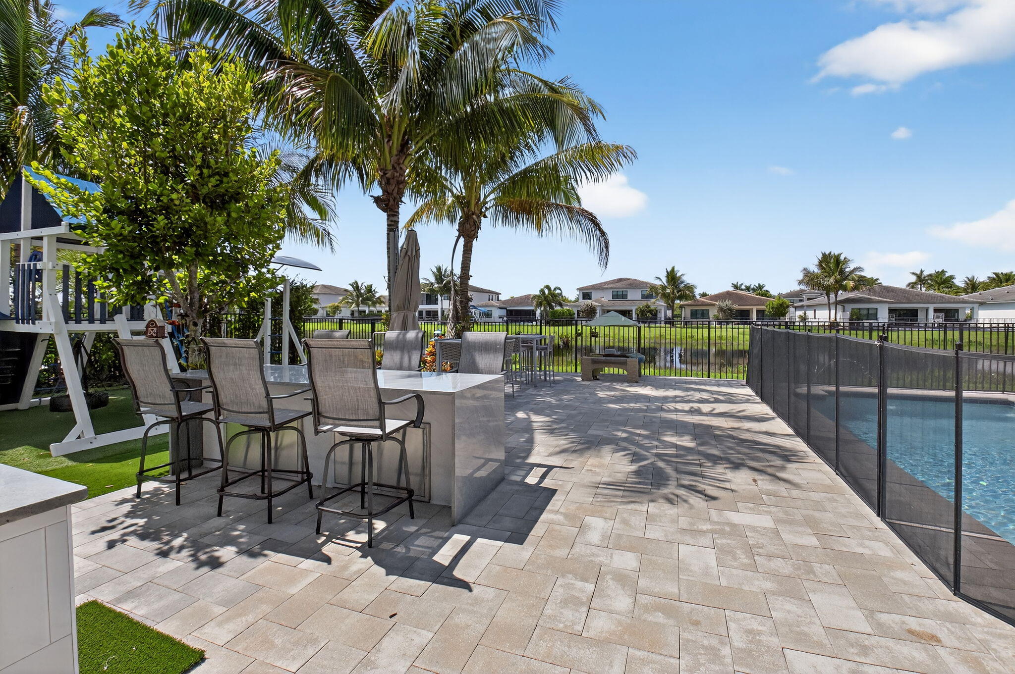 8858 Skyward Street Boca Raton, FL 33496 - Photo 71 of 116 Quartz seating area adjacent to pool