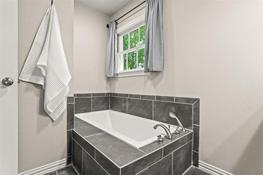 3116 Alexander Avenue Waco, TX 76708 - Photo 27 of 40 a bathroom with a sink a window and a bathtub