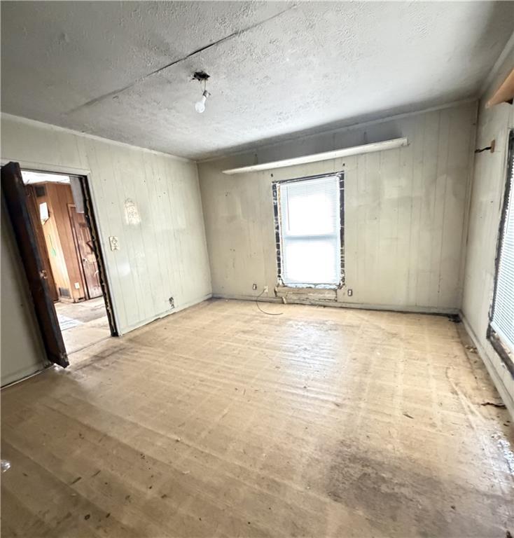 3 Walnut Street Aragon, GA 30104 - Photo 5 of 10 an empty room with a fireplace and windows