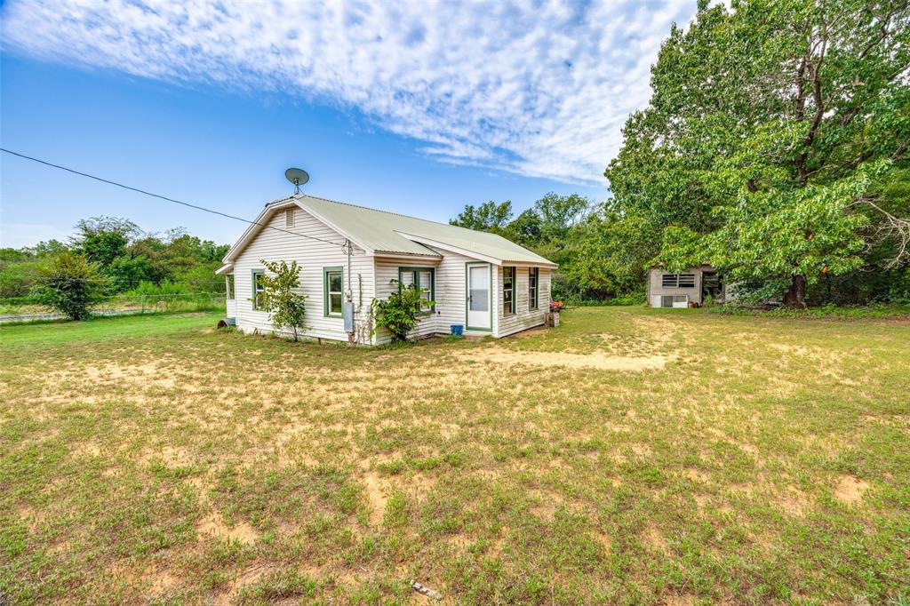 1549 Starr Road Denison, TX 75021 - Photo 3 of 13 a front view of a house with garden