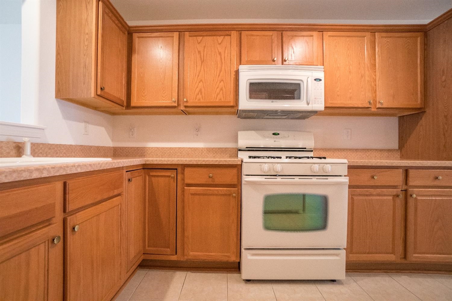 10647 Keystone Lane Crown Point, IN 46307 - Photo 6 of 10 a kitchen with granite countertop white cabinets and white appliances