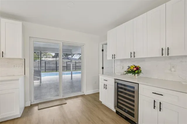 a room with wooden floor and white walls