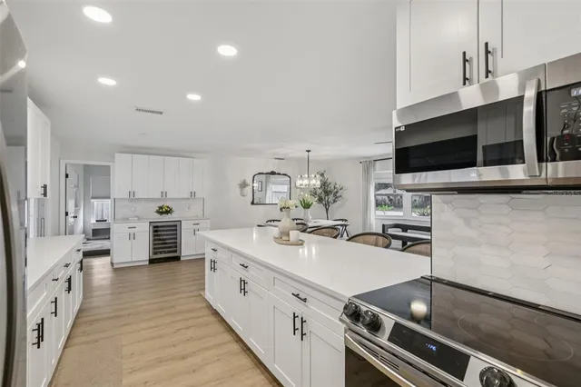 a kitchen with stainless steel appliances a sink stove and cabinets