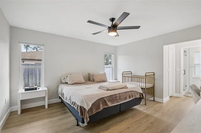 a bedroom with a bed and a chandelier