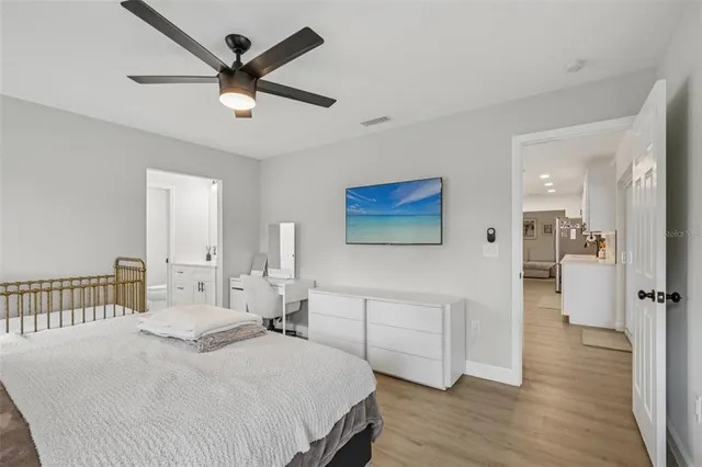 a bedroom with a bed a window and a chandelier