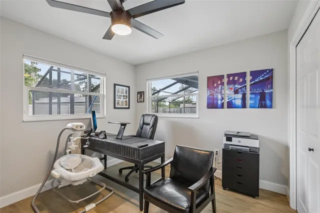 a view of a workspace with furniture and a window