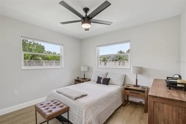 a bedroom with a bed dresser and a window