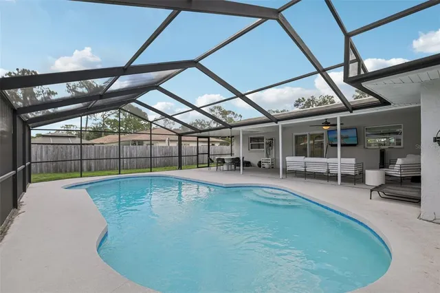 a view of backyard with wooden fence