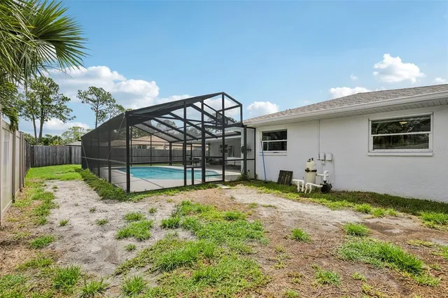 a view of a house with a yard and sitting area