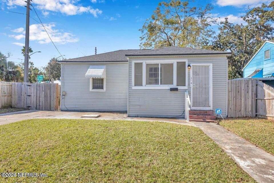 1804 Cleveland Street Jacksonville, FL 32209 - Photo 1 of 25 a view of a house with a yard and wooden fence