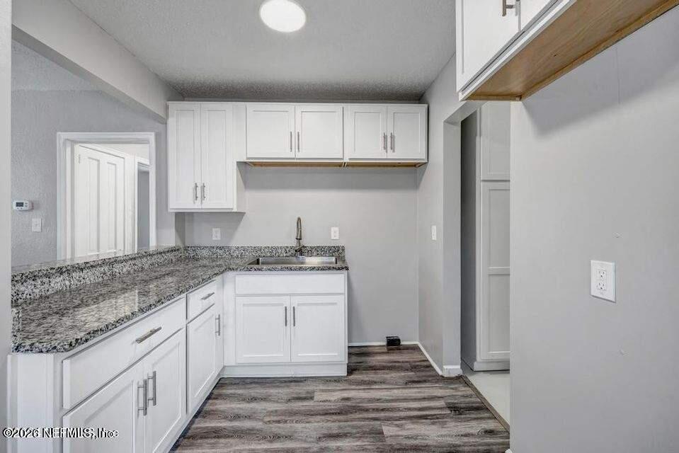 1804 Cleveland Street Jacksonville, FL 32209 - Photo 11 of 25 a kitchen with granite countertop a sink and cabinets
