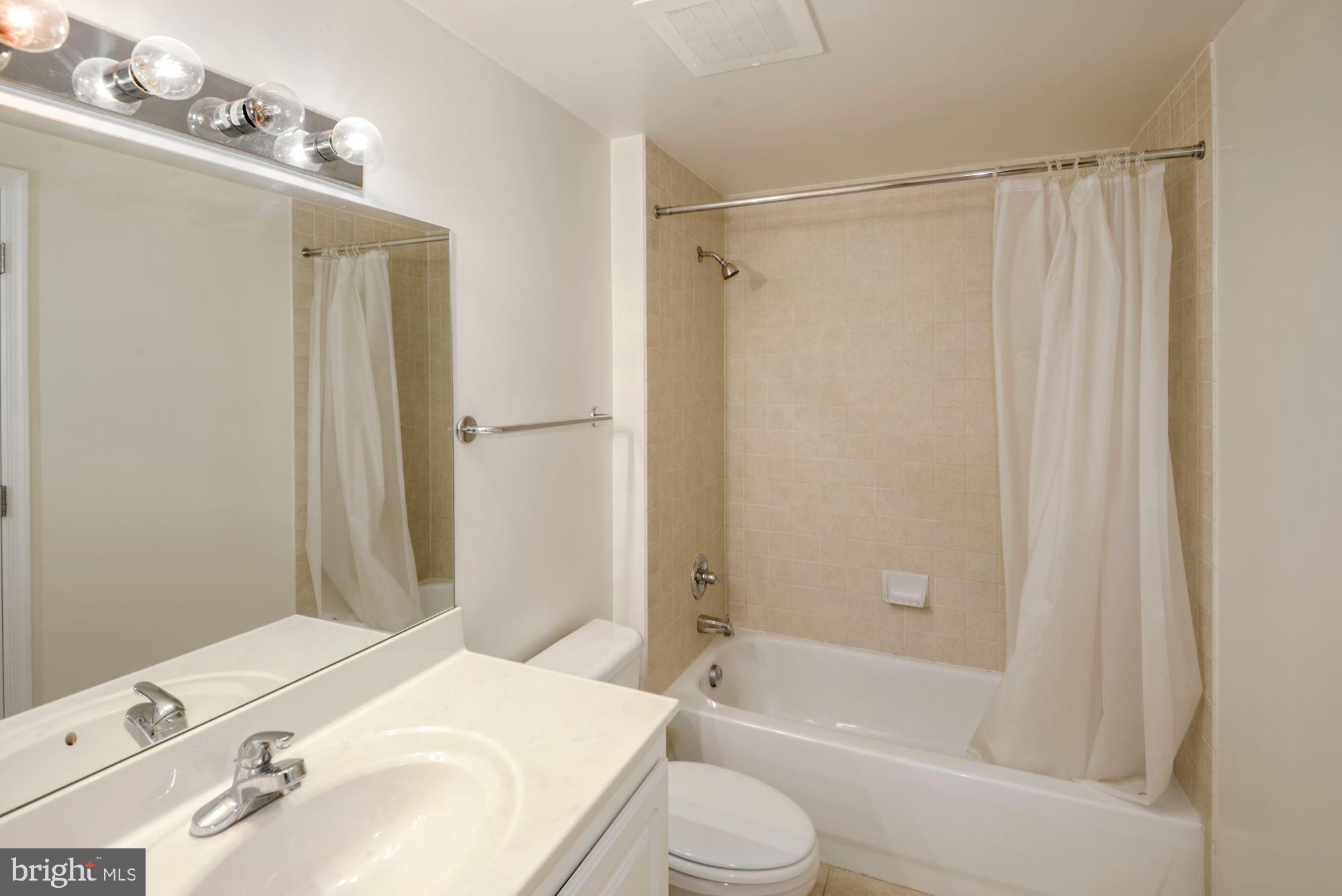 355 I Street Southwest, Unit S607 Washington, DC 20024 - Photo 12 of 27 a bathroom with a sink toilet and shower