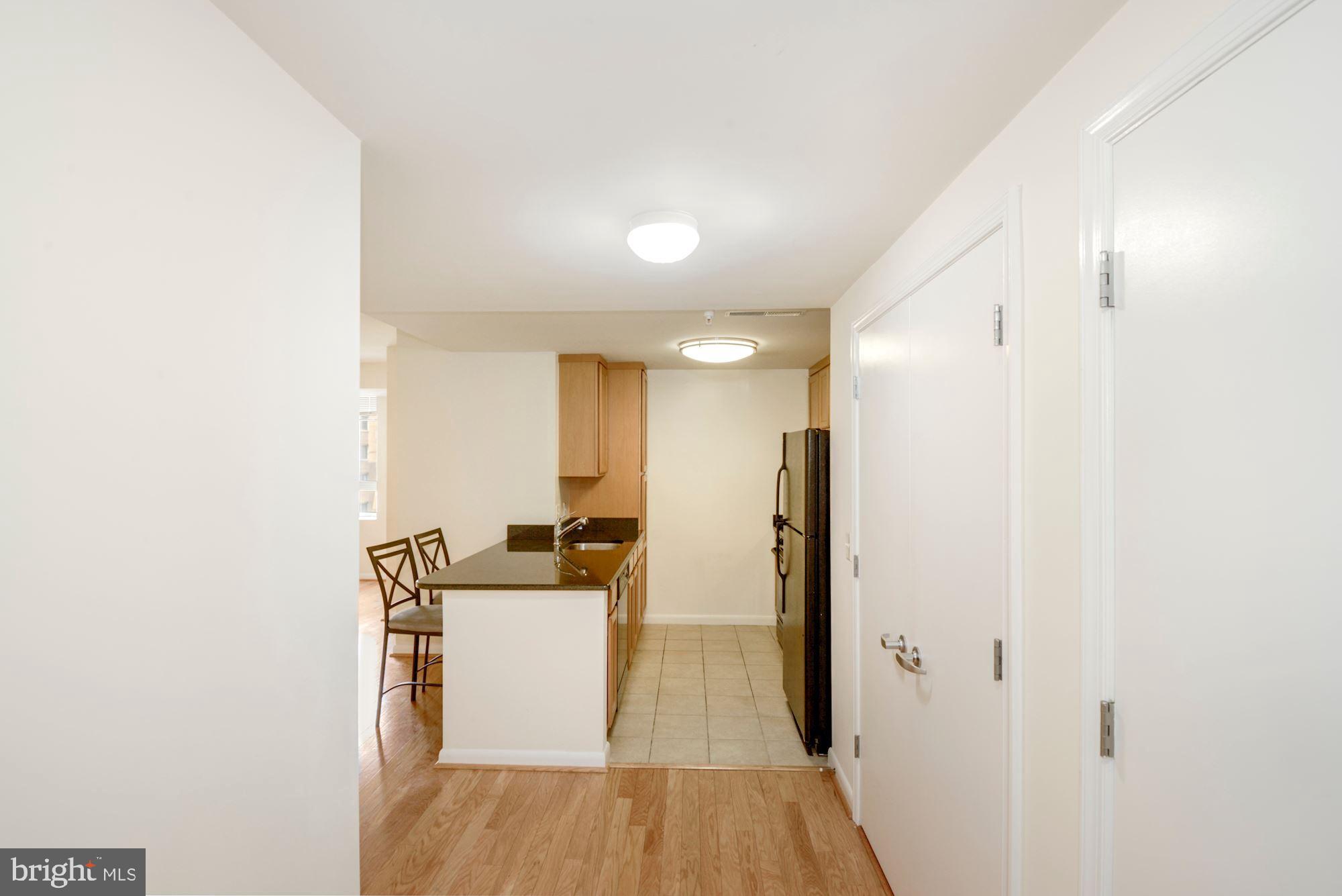 355 I Street Southwest, Unit S607 Washington, DC 20024 - Photo 3 of 27 a view of a kitchen from the hallway