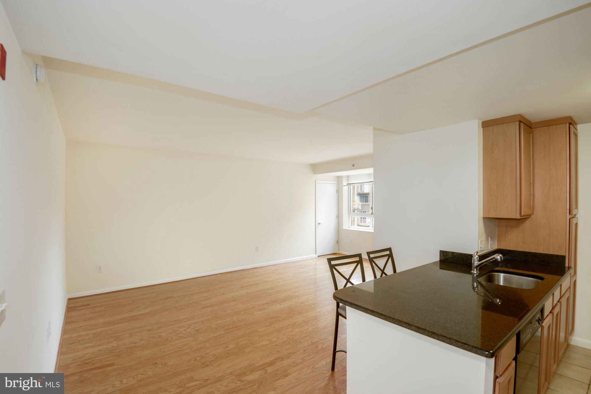 355 I Street Southwest, Unit S607 Washington, DC 20024 - Photo 4 of 27 a kitchen with granite countertop a sink and a stove top oven
