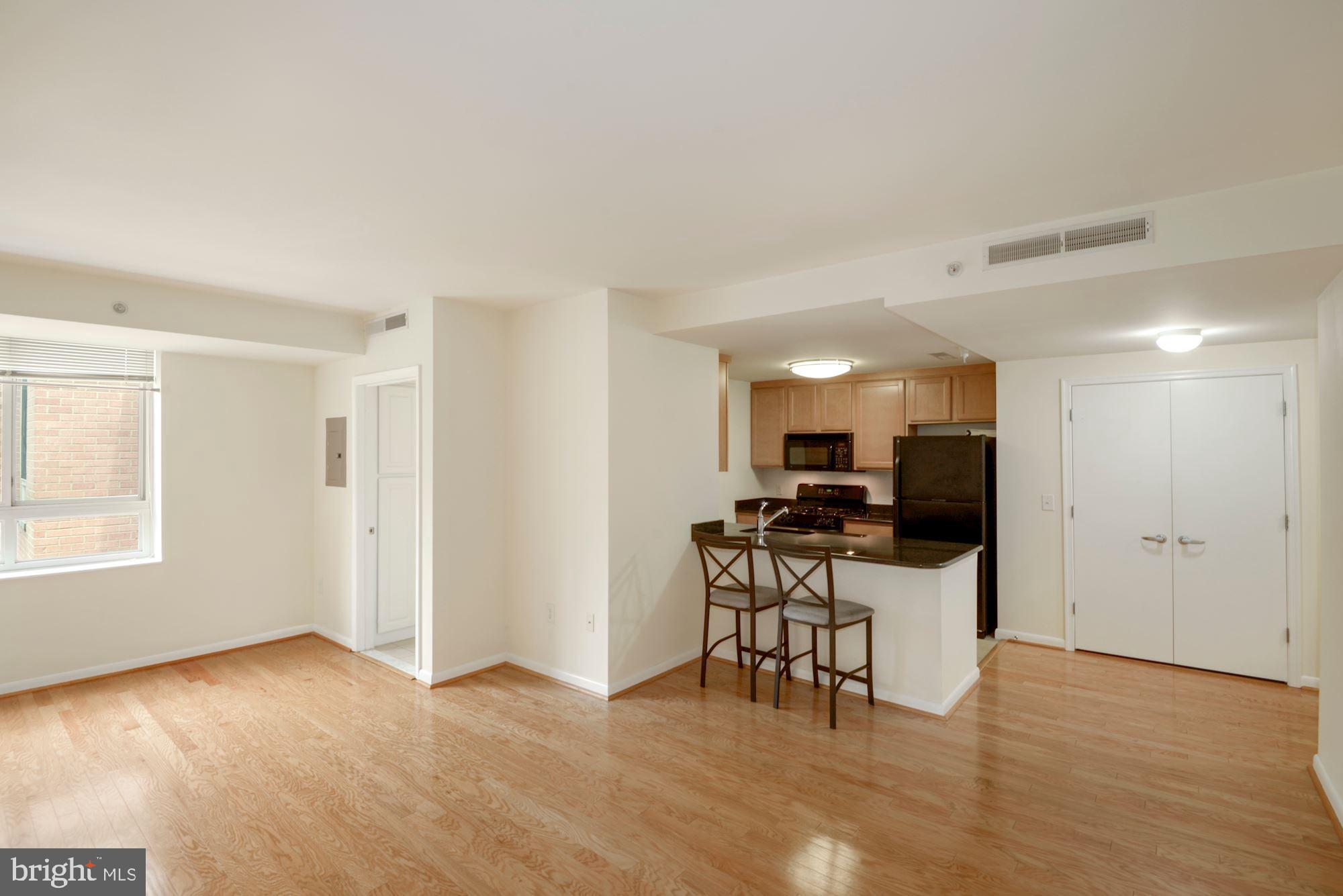 355 I Street Southwest, Unit S607 Washington, DC 20024 - Photo 5 of 27 a kitchen with a table and chairs in it