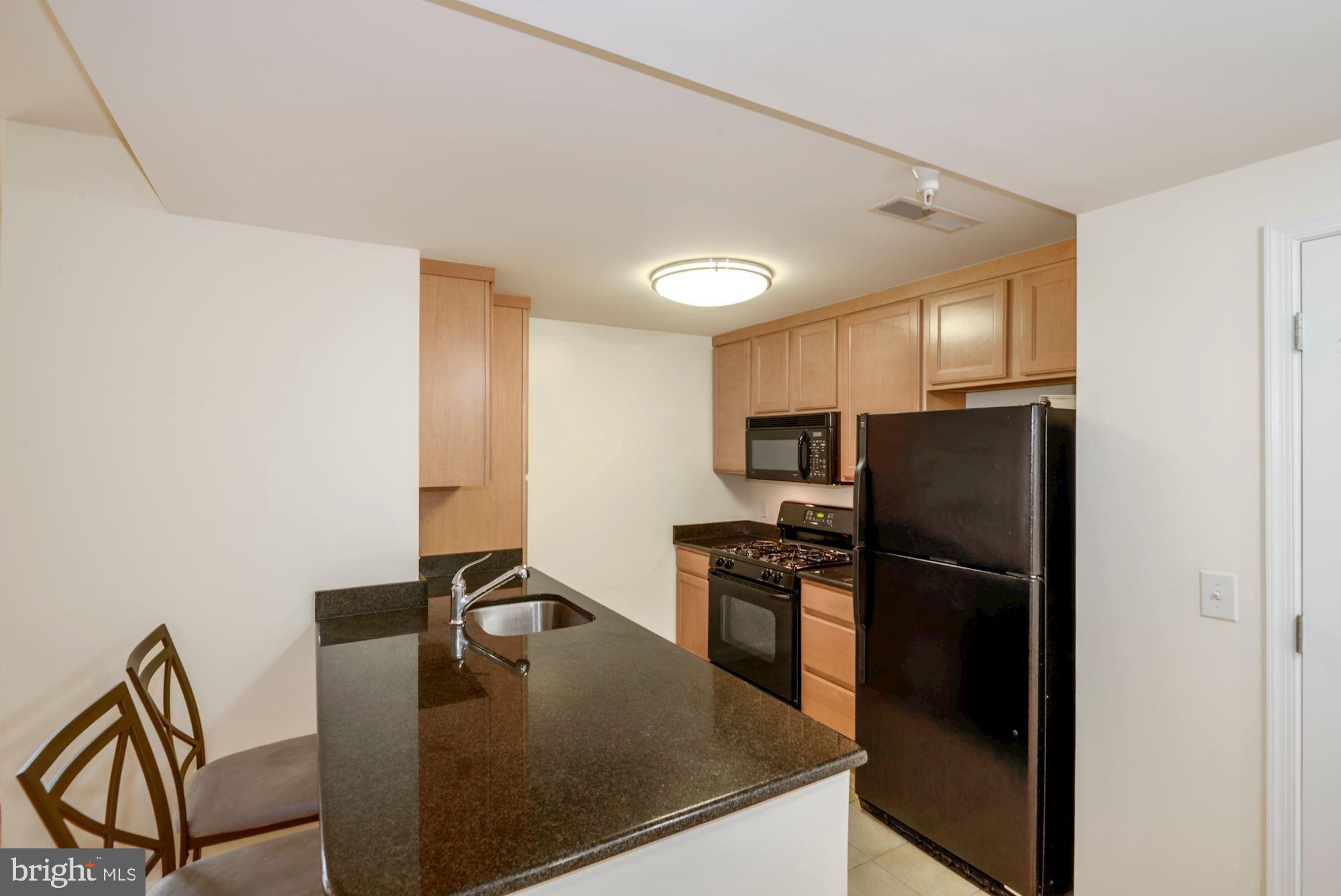 355 I Street Southwest, Unit S607 Washington, DC 20024 - Photo 8 of 27 a kitchen with a refrigerator and a stove top oven