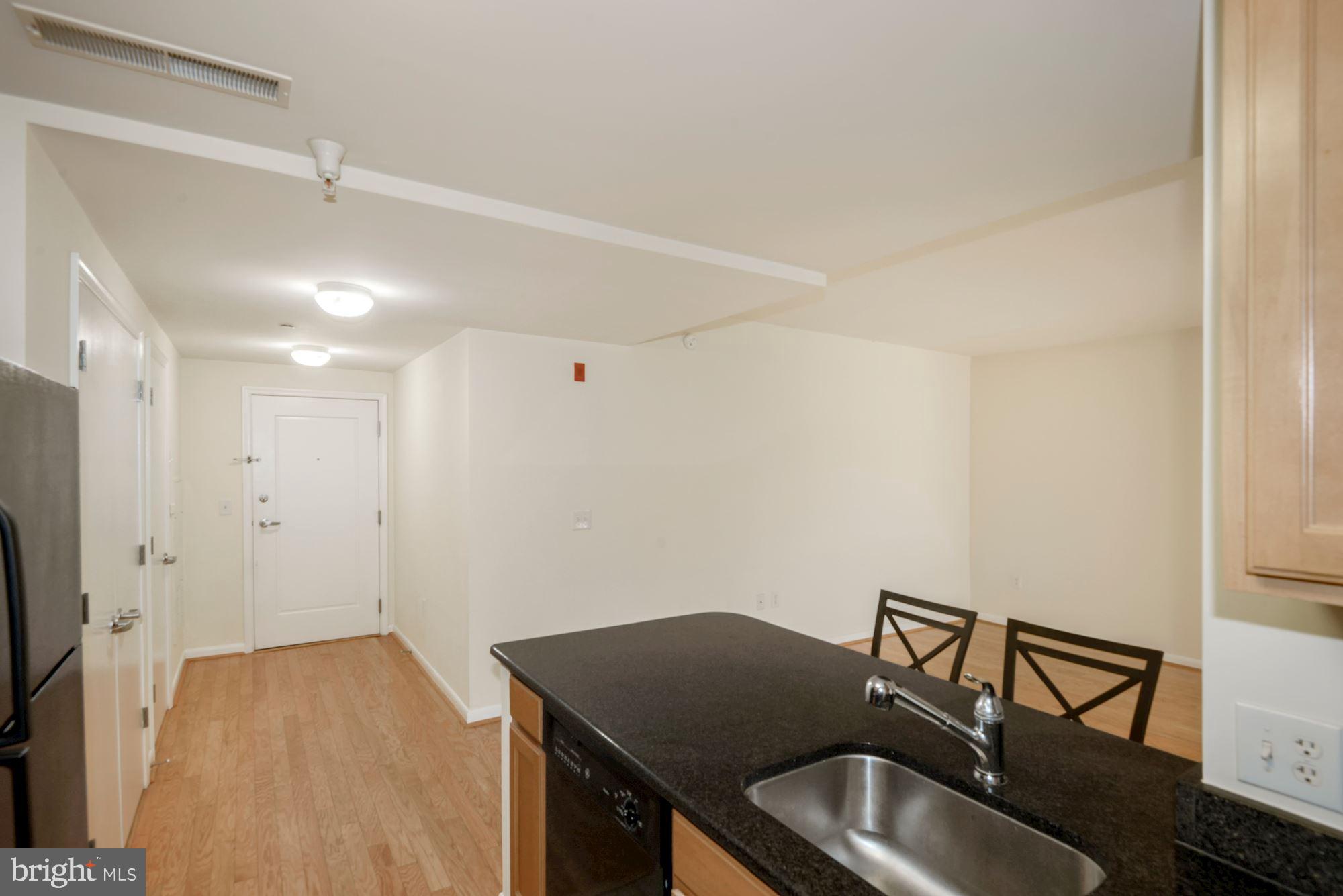 355 I Street Southwest, Unit S607 Washington, DC 20024 - Photo 10 of 27 a room with a sink and a refrigerator