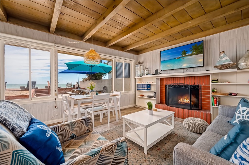 a living room with furniture a fireplace and a table