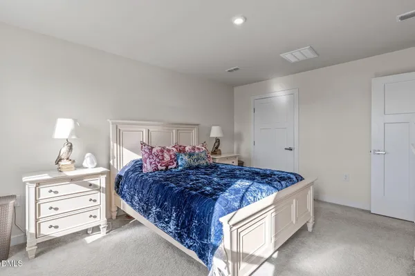 a bed room with a bed and a dresser