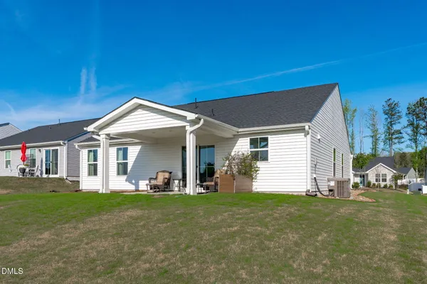 a front view of a house with a yard and porch