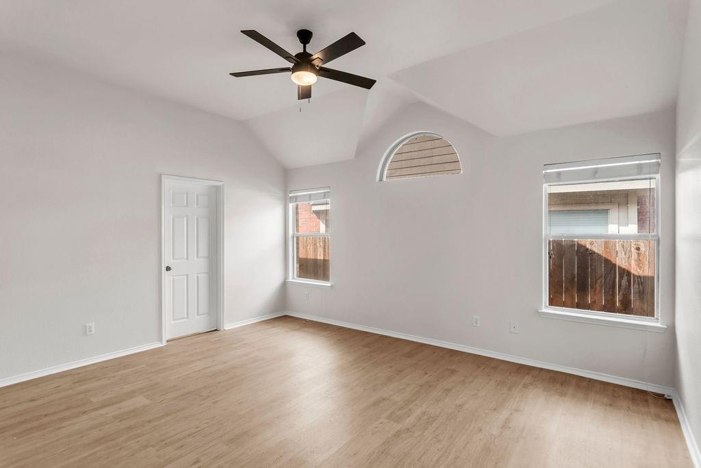 447 Trinity Drive Allen, TX 75002 - Photo 16 of 24 a view of an empty room with a window and wooden floor