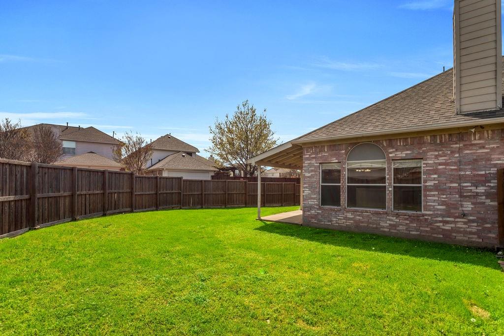 447 Trinity Drive Allen, TX 75002 - Photo 23 of 24 a view of a backyard with potted plants and large tree