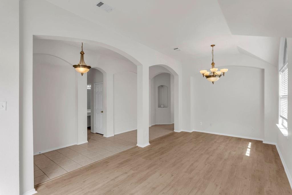 447 Trinity Drive Allen, TX 75002 - Photo 4 of 24 wooden floor in an empty room with a window