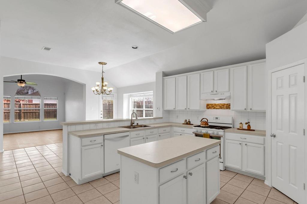 447 Trinity Drive Allen, TX 75002 - Photo 6 of 24 a kitchen with a sink window and cabinets