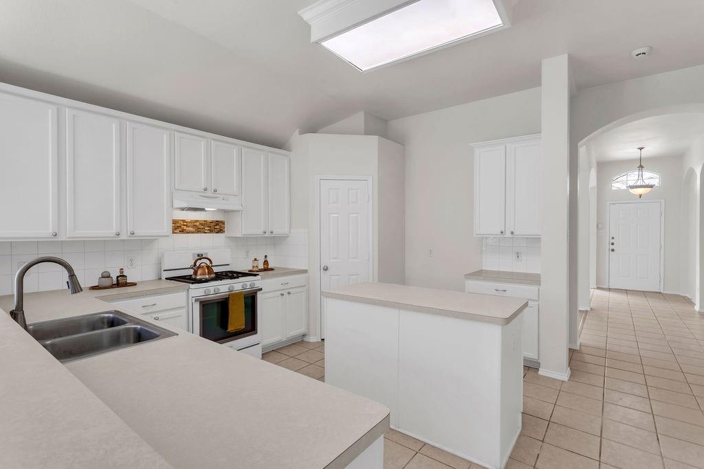 447 Trinity Drive Allen, TX 75002 - Photo 8 of 24 a kitchen with appliances a sink and cabinets