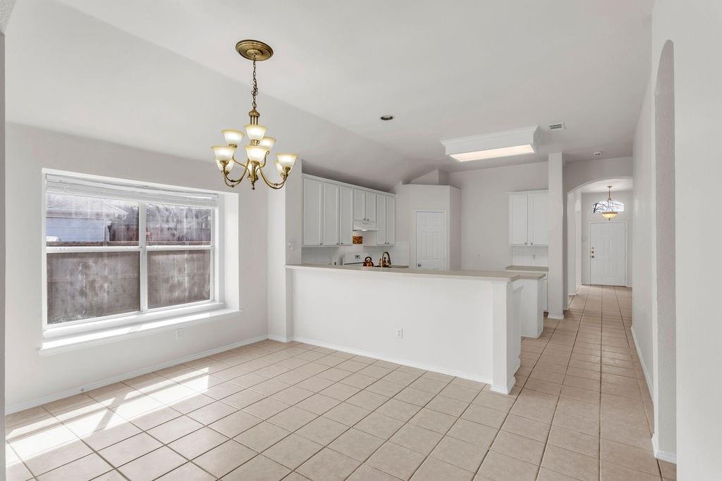 447 Trinity Drive Allen, TX 75002 - Photo 10 of 24 a hallway with windows and chandelier