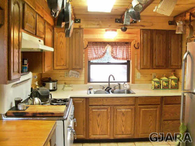 989 17 Road Fruita, CO 81521 - Photo 3 of 23 a bathroom with a granite countertop sink a mirror and shower