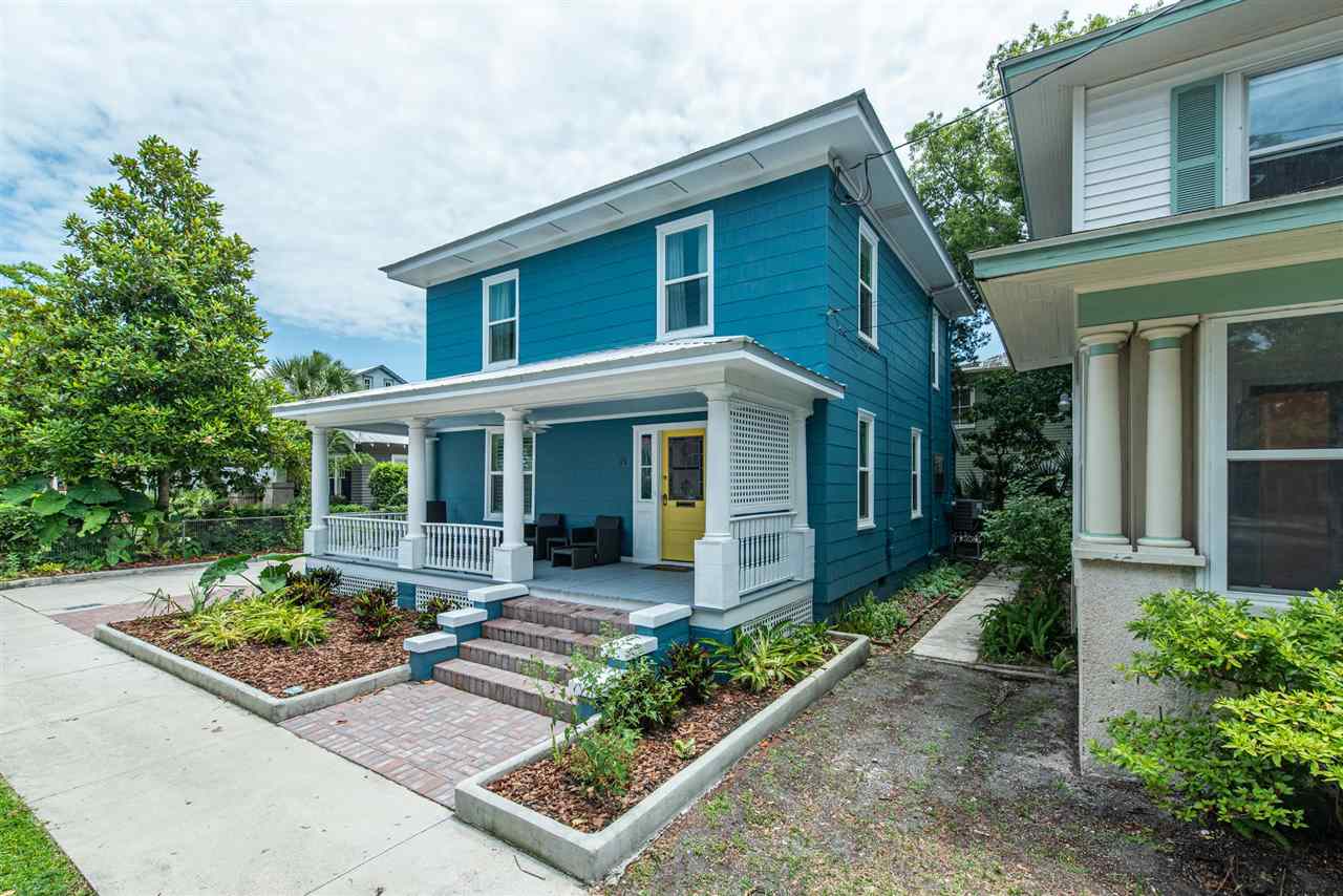 front view of a house with potted plants