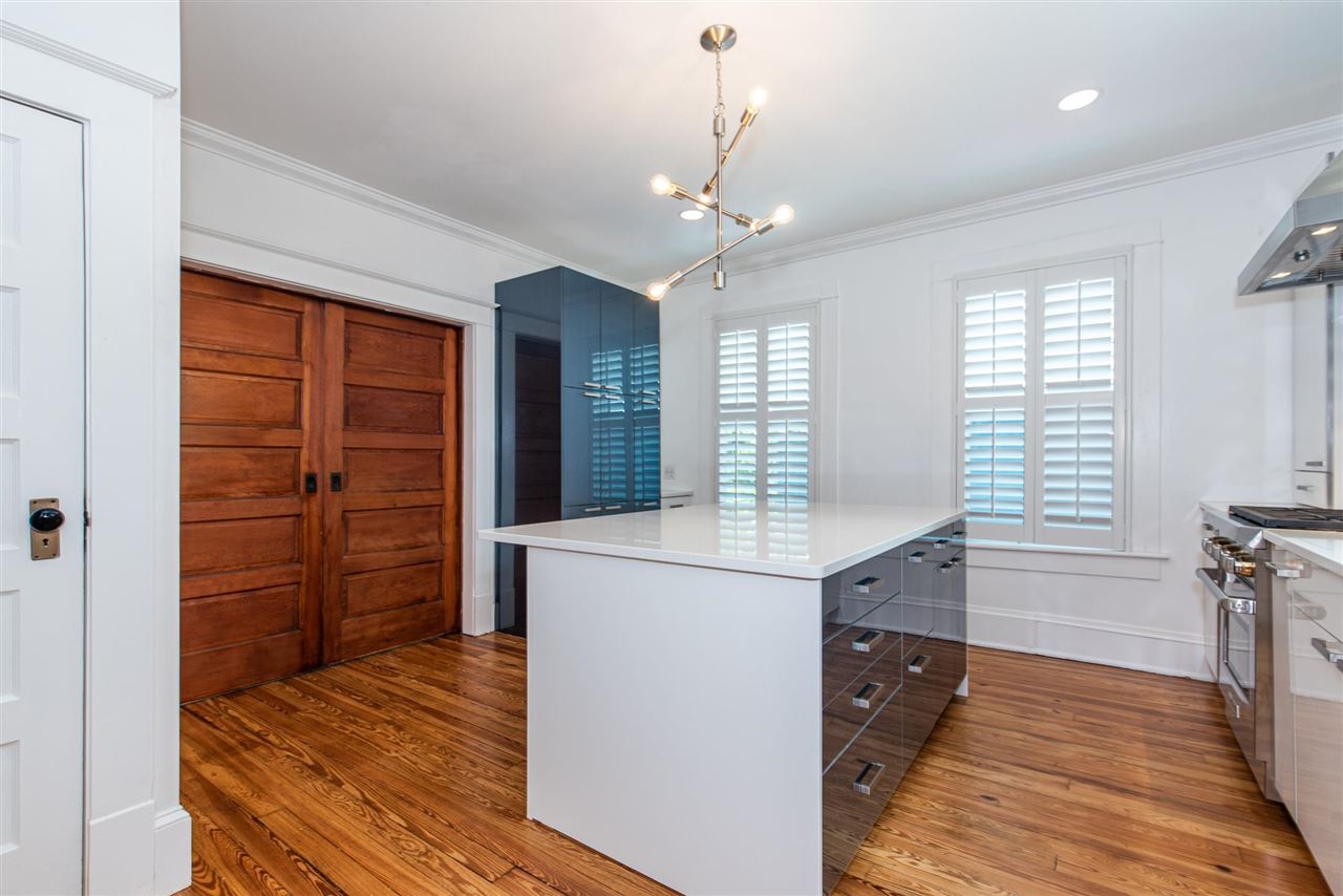 21 Saragossa Street St. Augustine, FL 32084 - Photo 13 of 46 a kitchen with kitchen island a counter top space appliances and a window