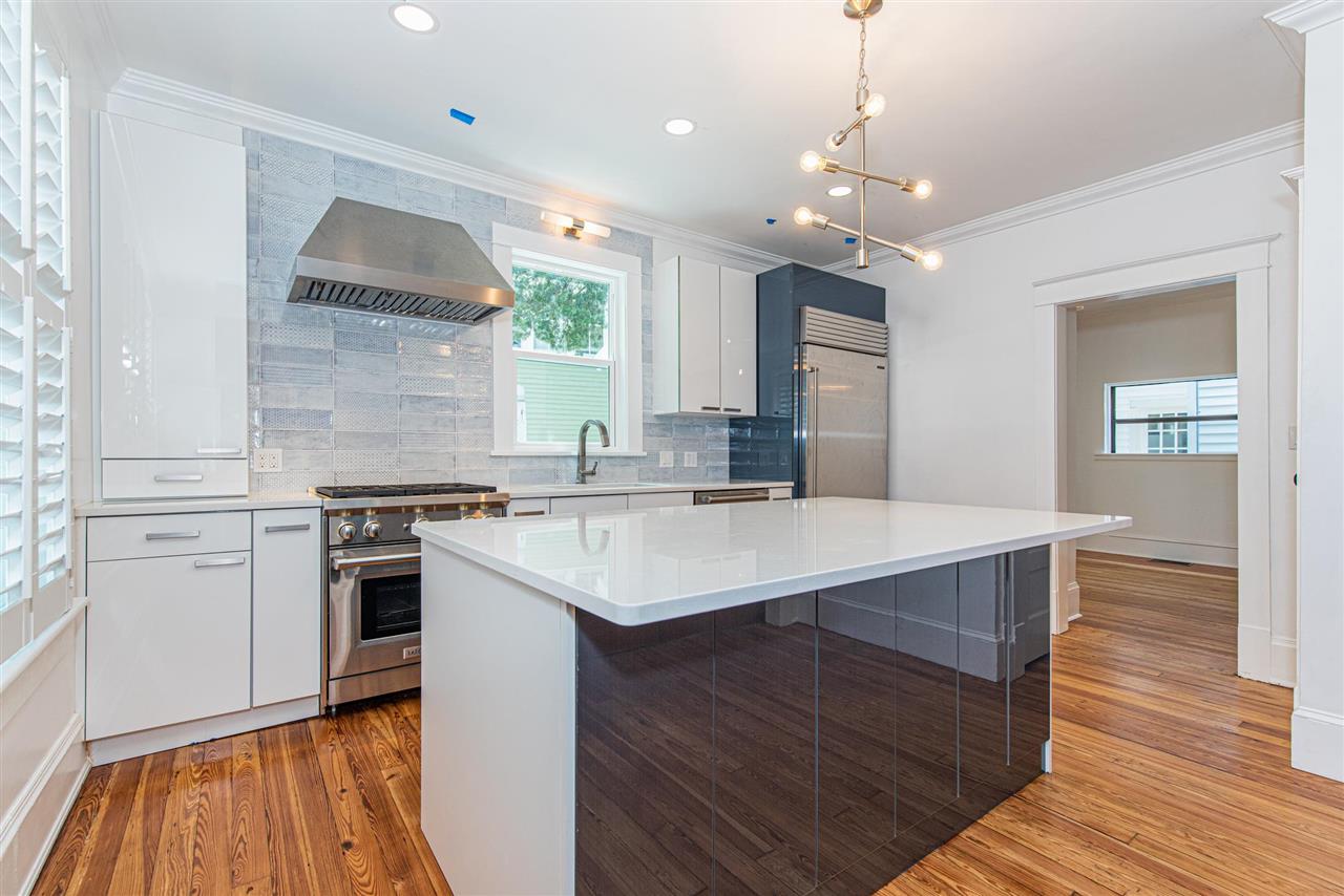 21 Saragossa Street St. Augustine, FL 32084 - Photo 15 of 46 a kitchen with a sink appliances wooden floor and a window