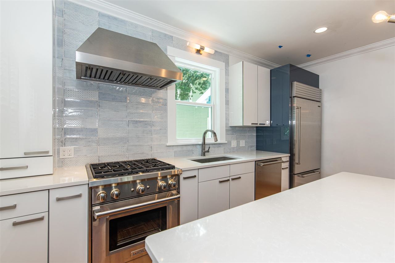 21 Saragossa Street St. Augustine, FL 32084 - Photo 18 of 46 a kitchen with a stove a sink and a refrigerator