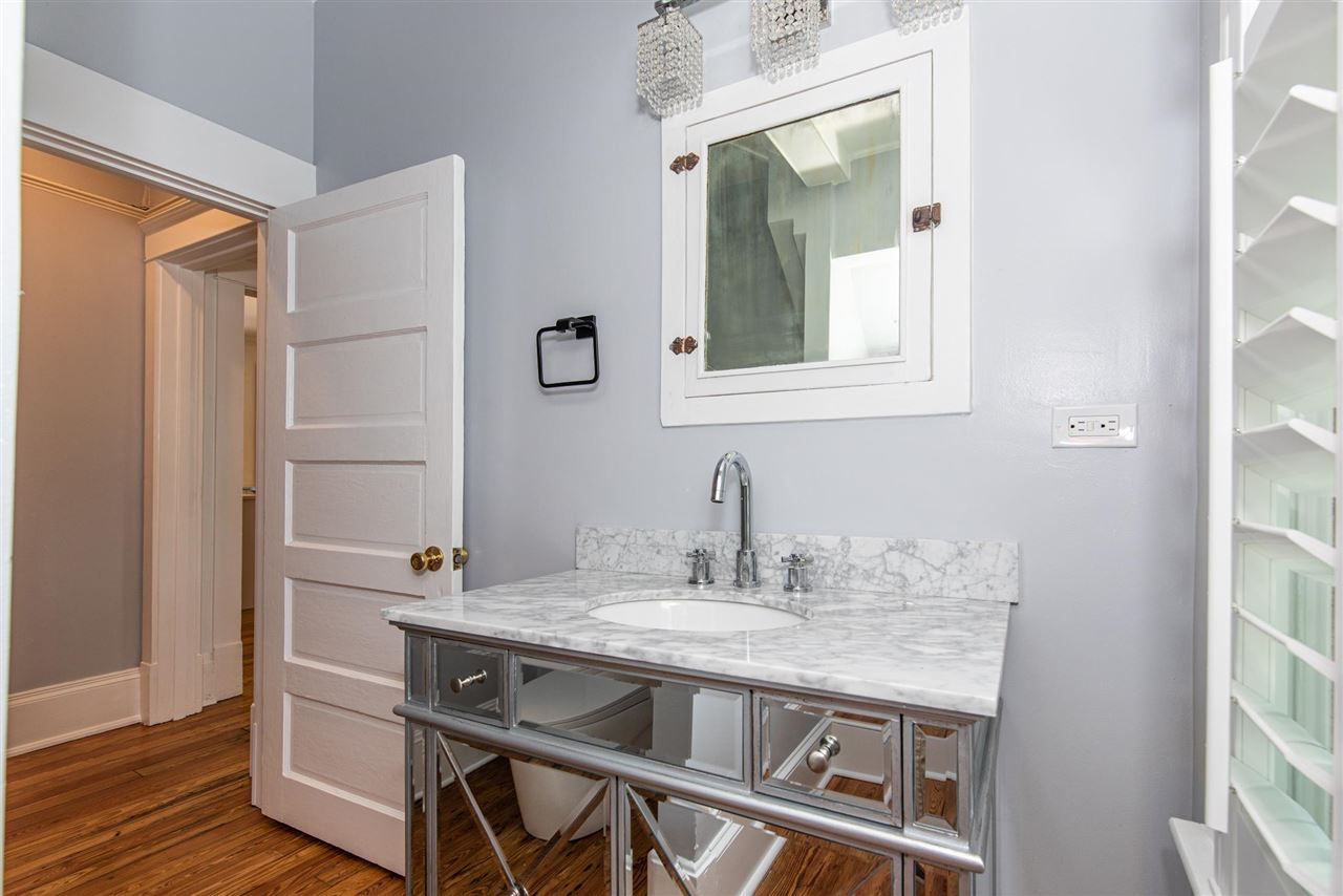 21 Saragossa Street St. Augustine, FL 32084 - Photo 28 of 46 a view of bathroom with sink mirror and wooden floor