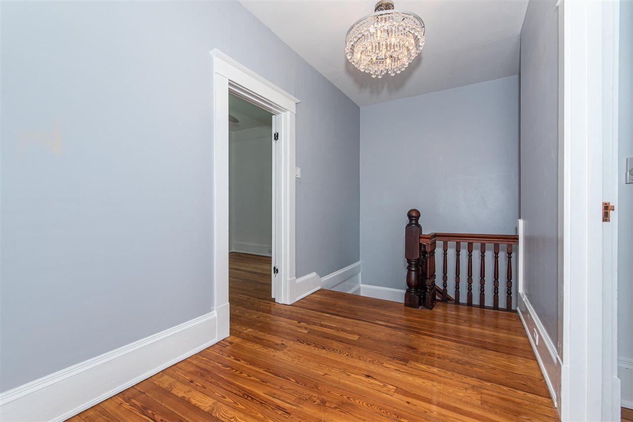 21 Saragossa Street St. Augustine, FL 32084 - Photo 29 of 46 a view of a hallway with wooden floor