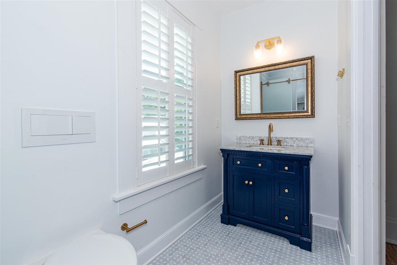 21 Saragossa Street St. Augustine, FL 32084 - Photo 33 of 46 a bathroom with a sink vanity and mirror