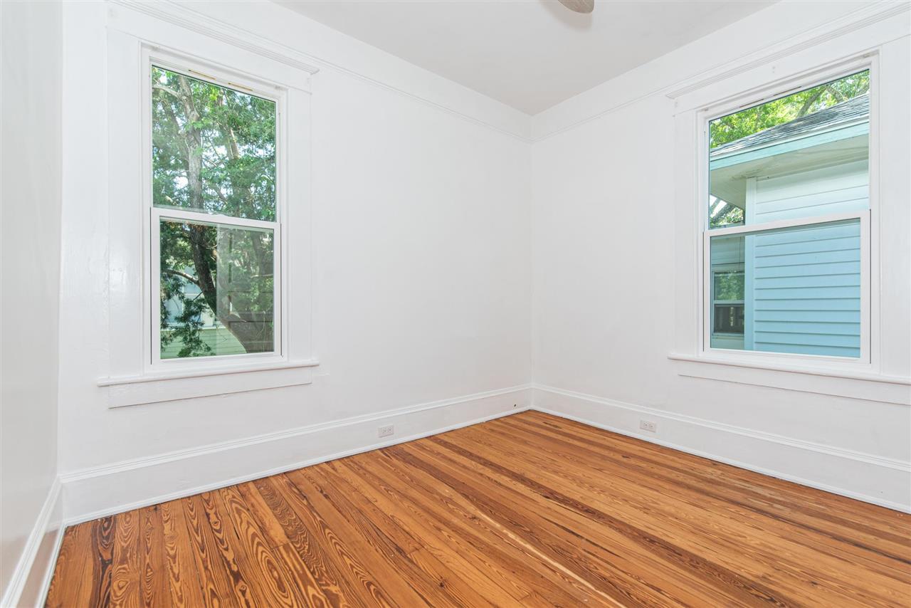 21 Saragossa Street St. Augustine, FL 32084 - Photo 36 of 46 an empty room with wooden floor and windows
