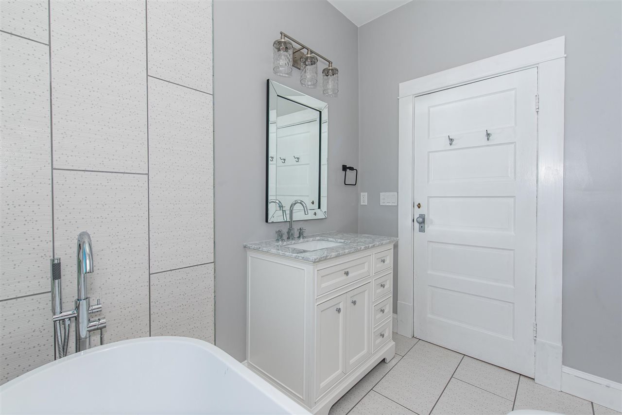 21 Saragossa Street St. Augustine, FL 32084 - Photo 38 of 46 a bathroom with a granite countertop sink and a mirror